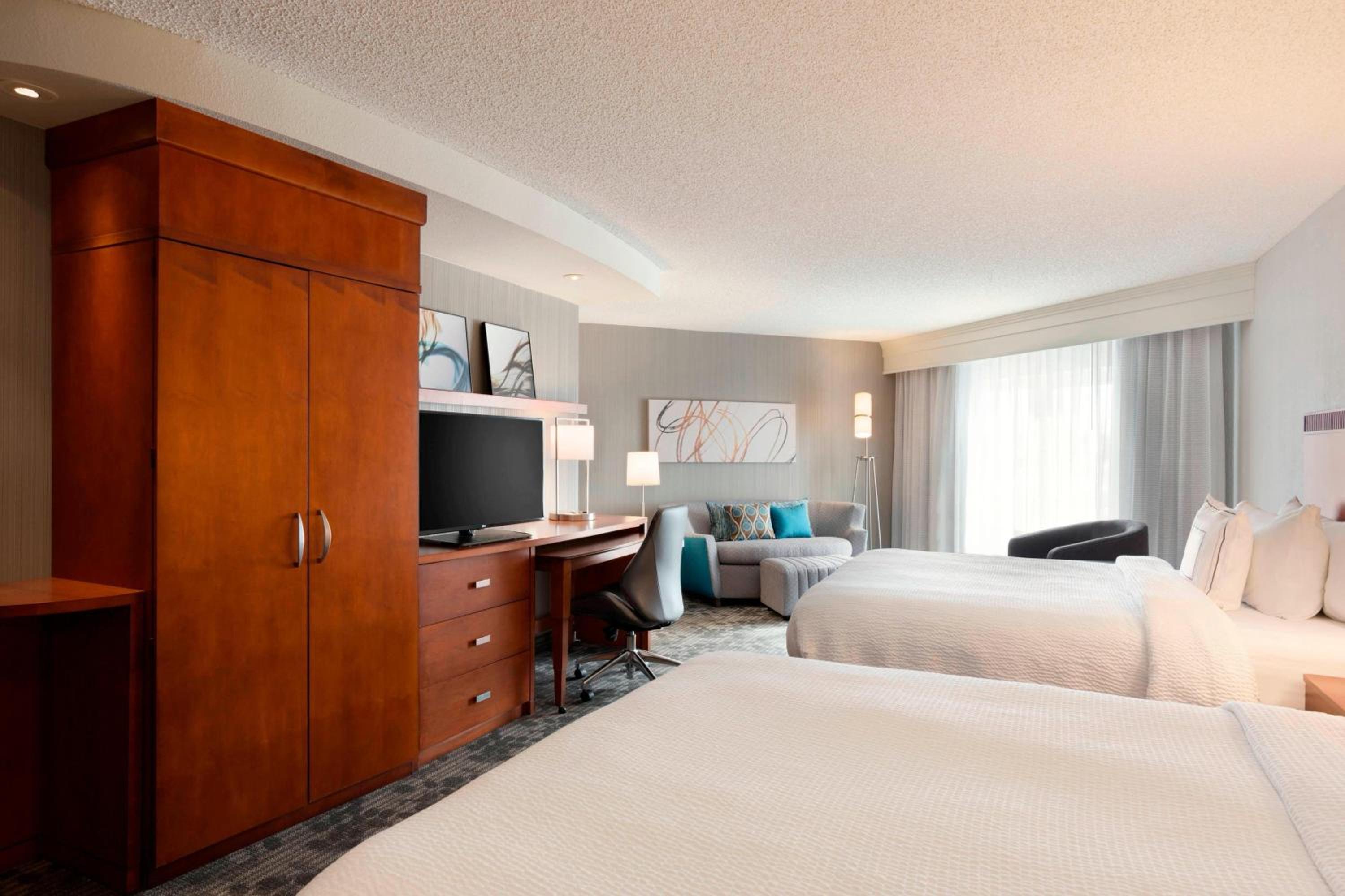 Queen Suite with Two Queen Beds and Sofa Bed - Photo 1