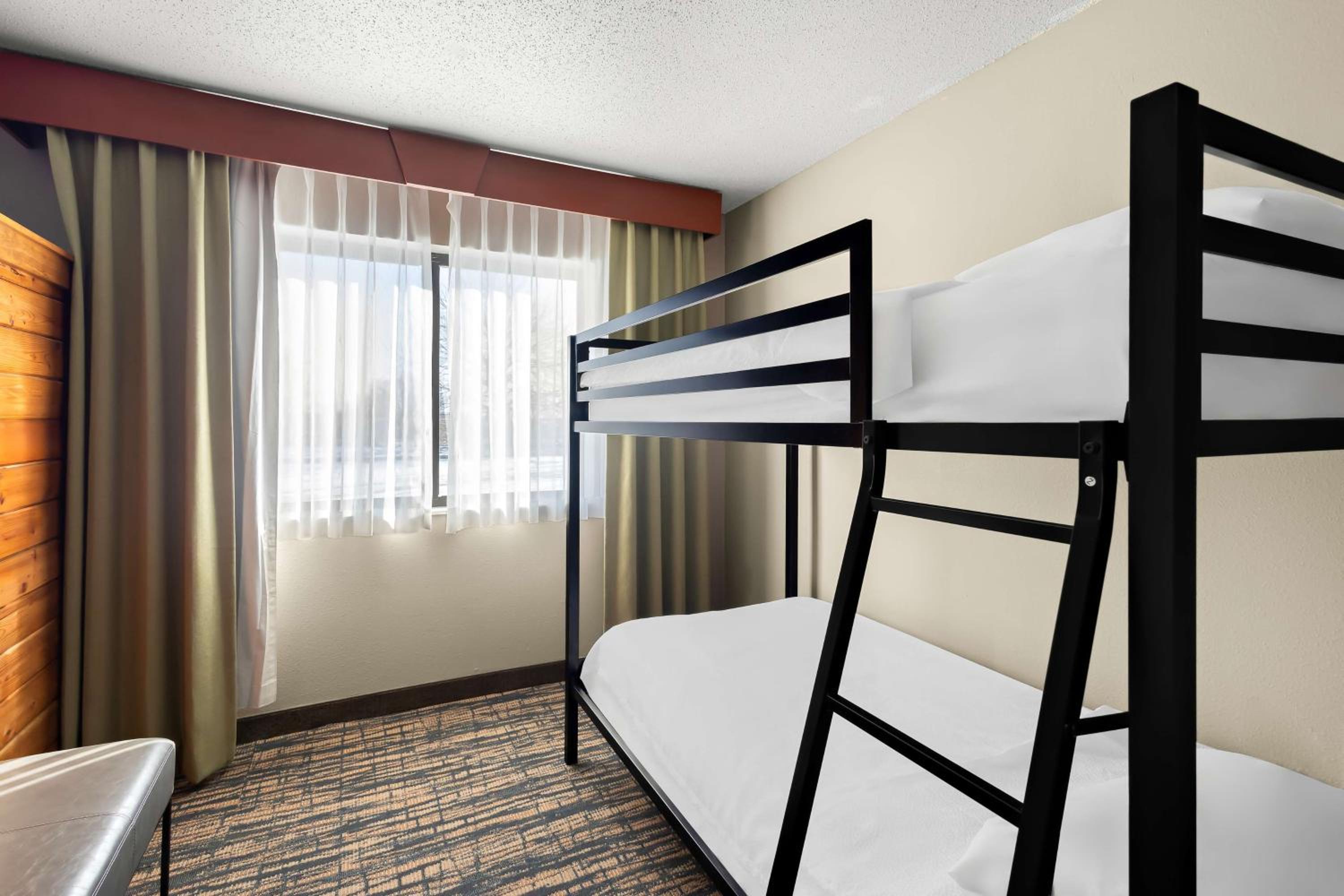 Family Two-Room Suite with One King and One Bunk Bed with Sofa Bed - Non-Smoking - Photo 1