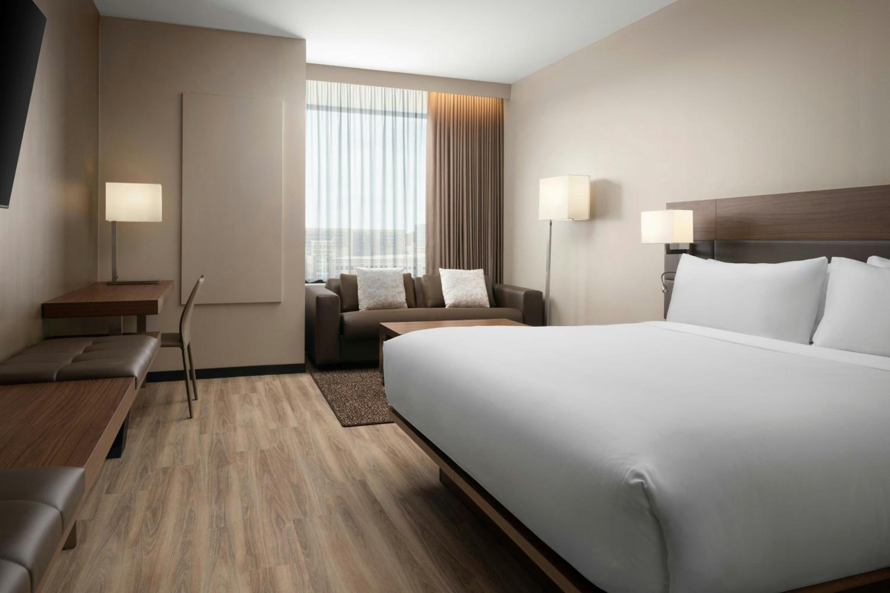 Deluxe King Room with Sofa Bed and City View - Photo 1