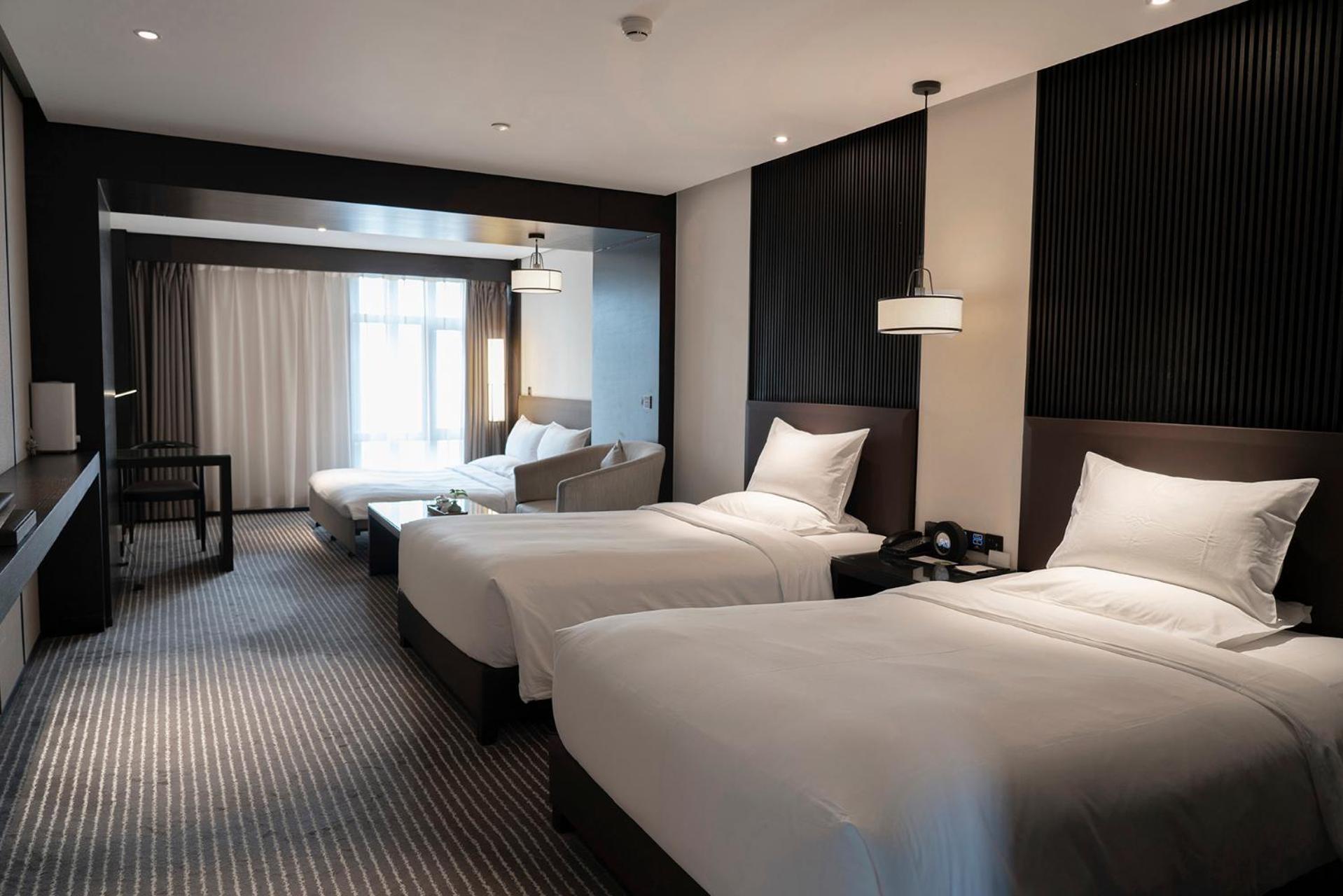 Deluxe Family Room with Two Double Beds and One King Sofa Bed