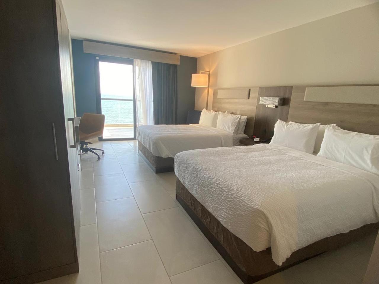 Standard Queen Room with Two Queen Beds and Balcony - Ocean View - Photo 1