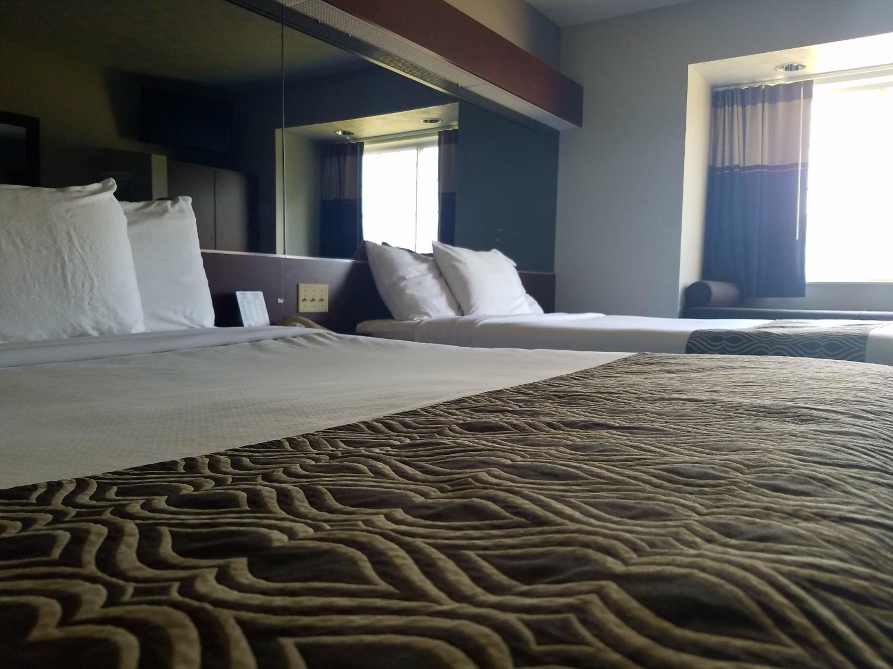 hotel room with two beds and a view of the window