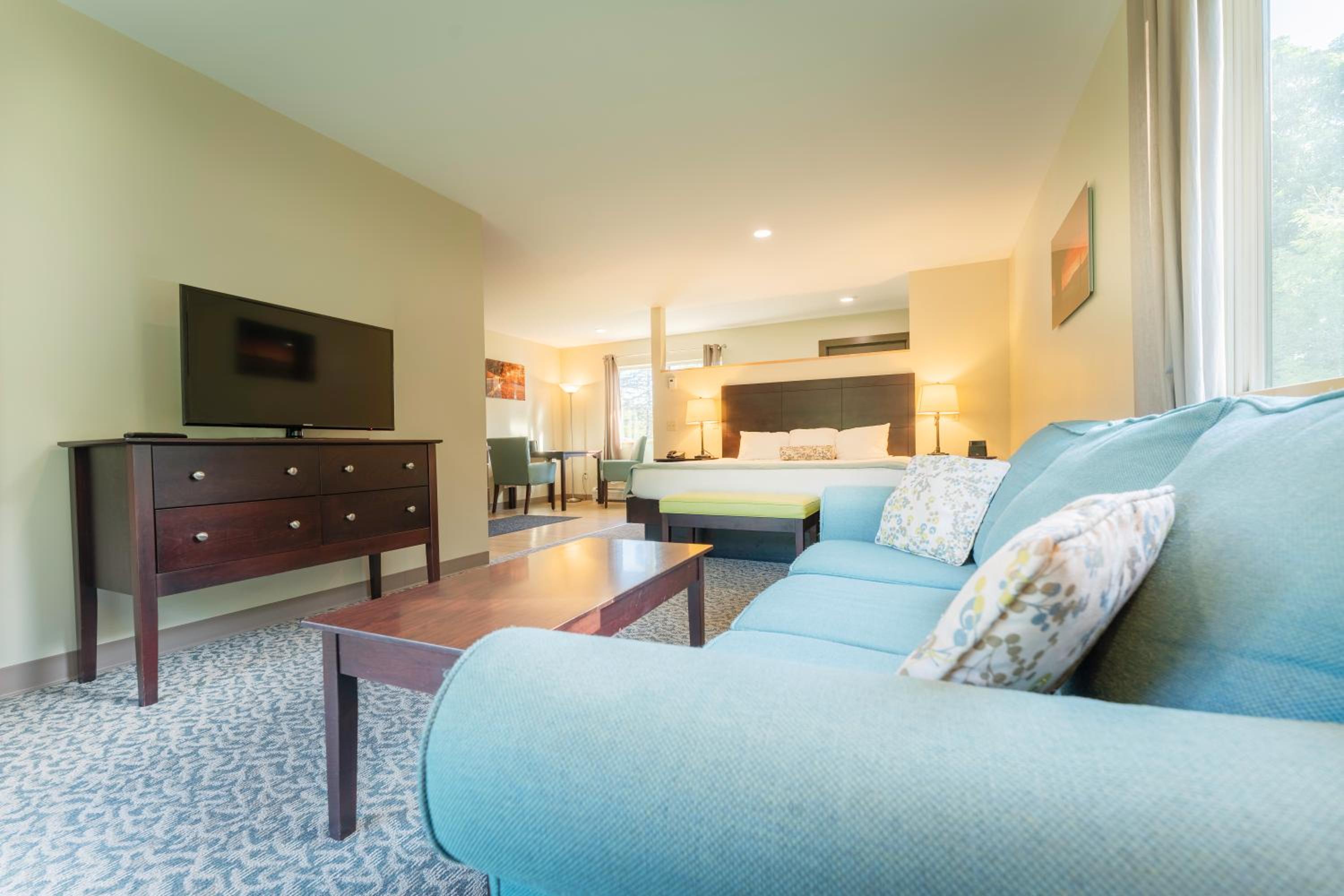 Hotel suite living area with sofa and TV