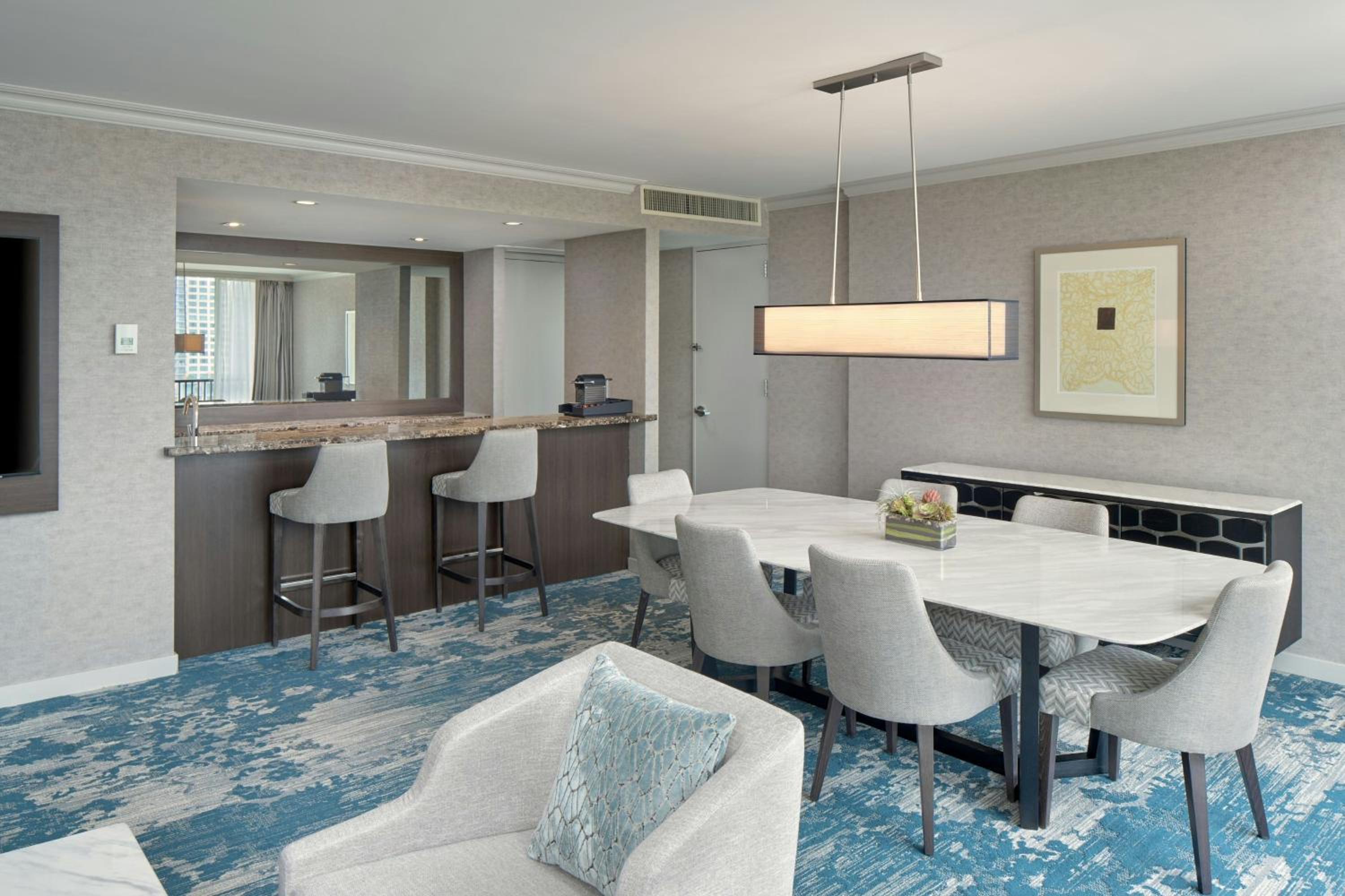 One-Bedroom King Suite with Harbor View, Living Room, Dining Area and Sofa Bed