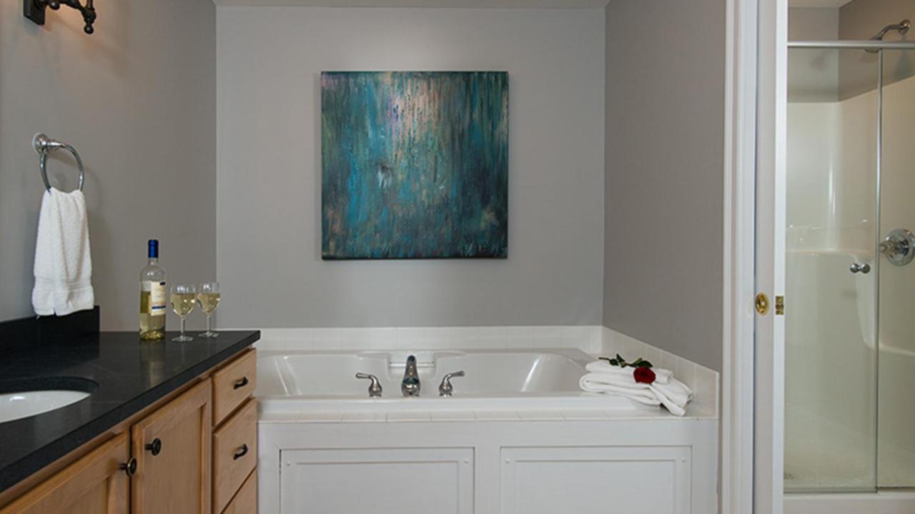 Bathroom with tub, sink, and wine