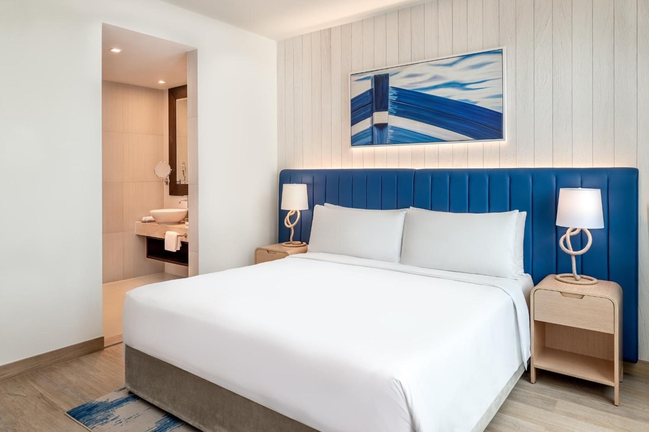 One-Bedroom Suite with Plaza View and Living/Dining Area - Theme Park