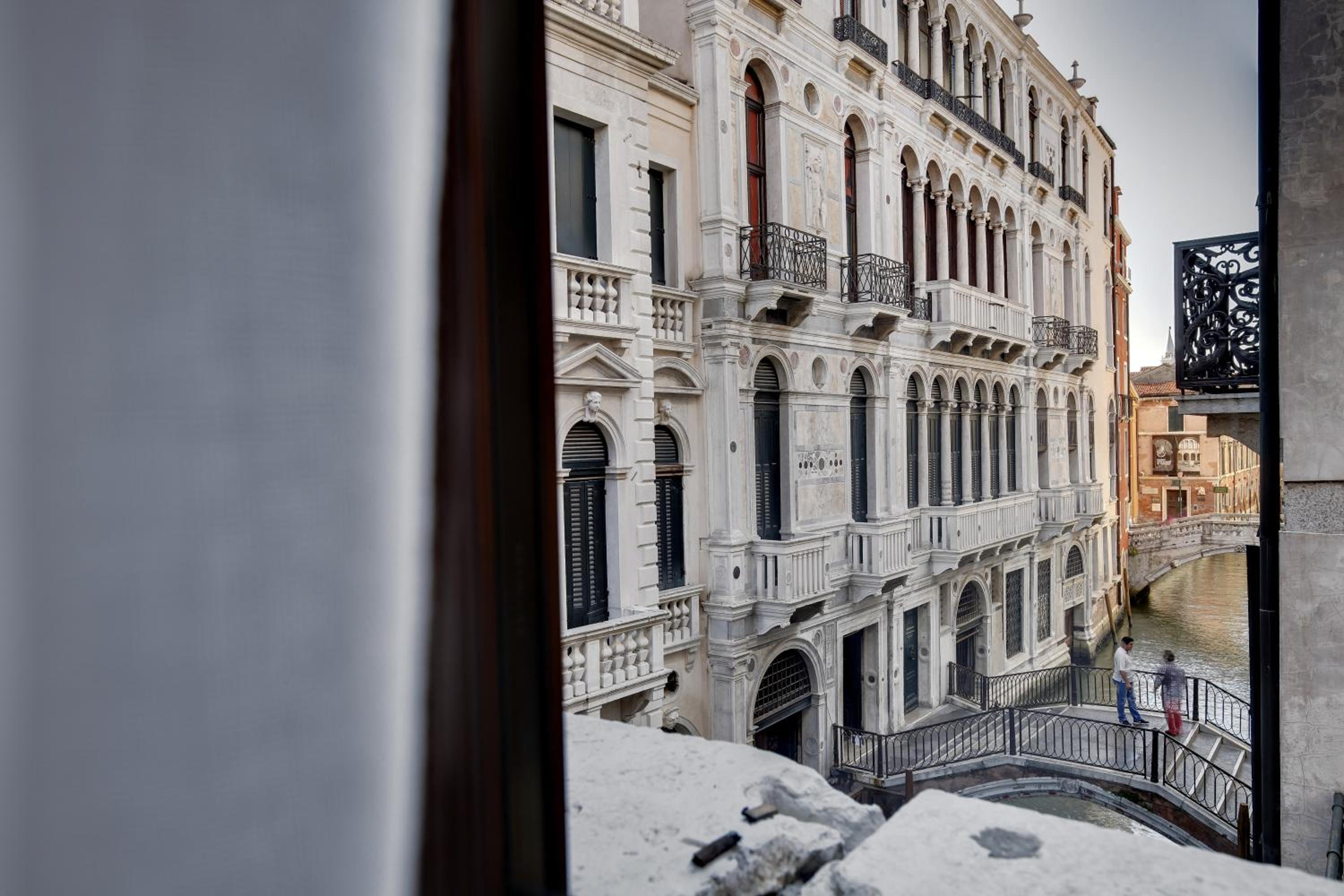 View of a canal and historic buildings from a window.