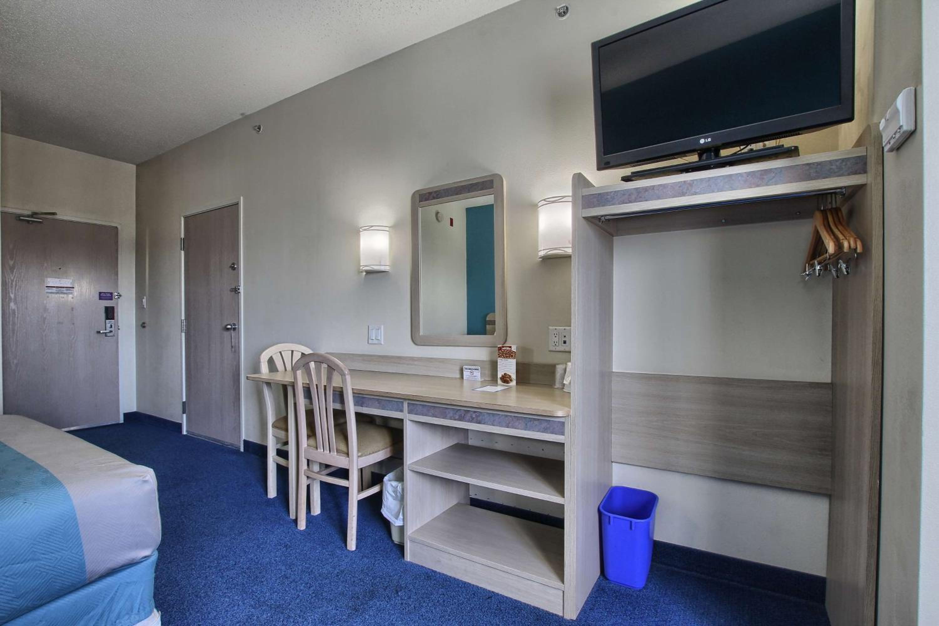 hotel room with two beds and a flat screen tv