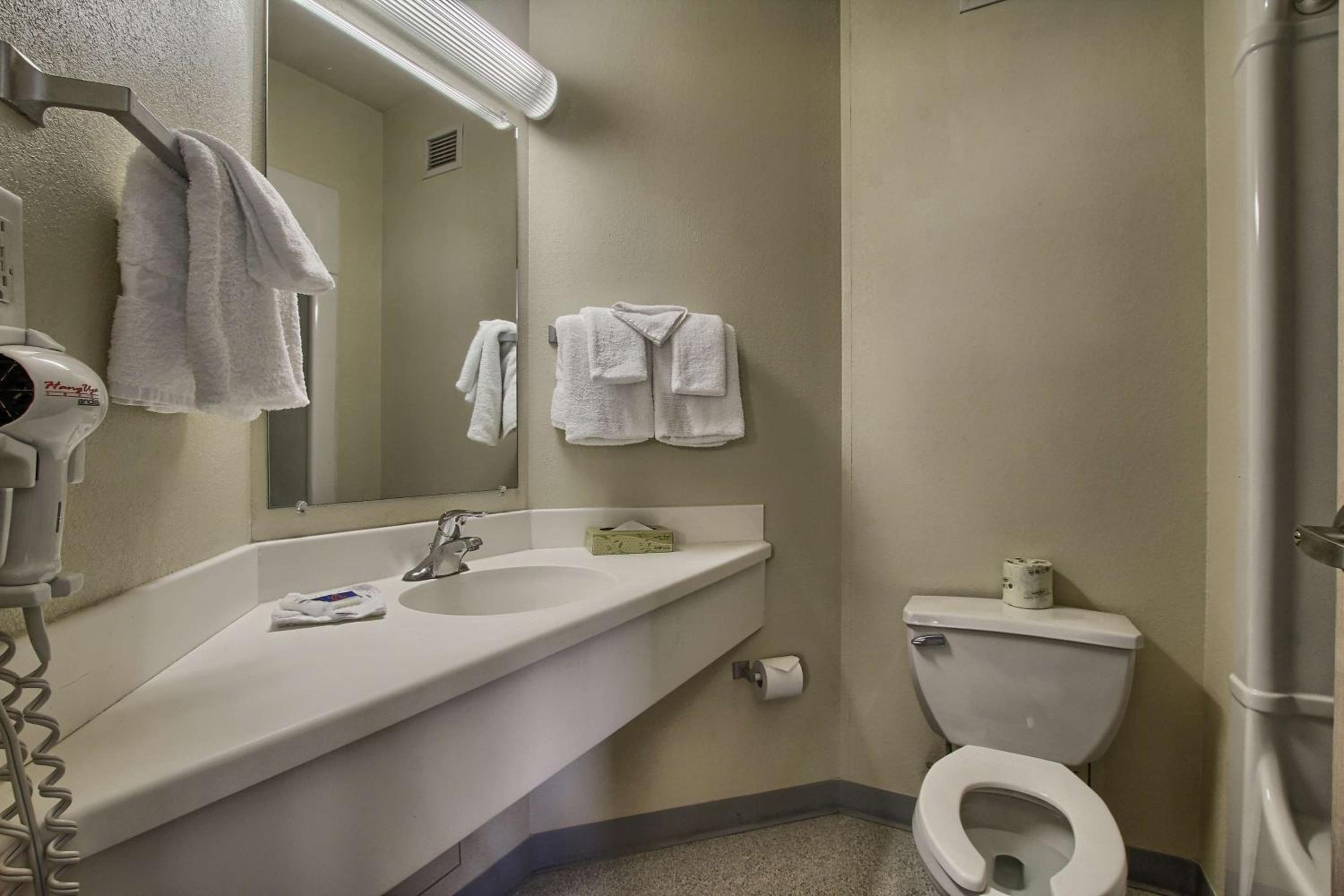 bathroom with a toilet, sink, and towel rack