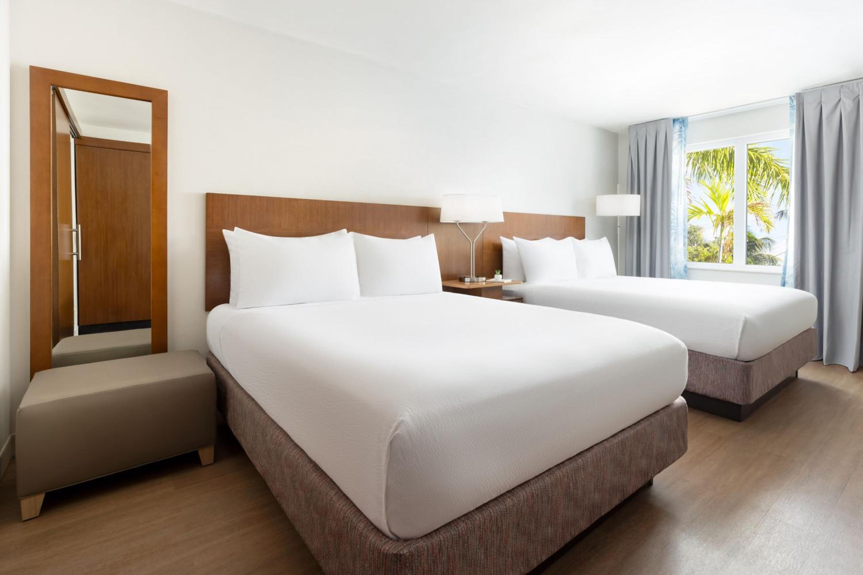 Deluxe Queen Room with Two Queen Beds and Pool View