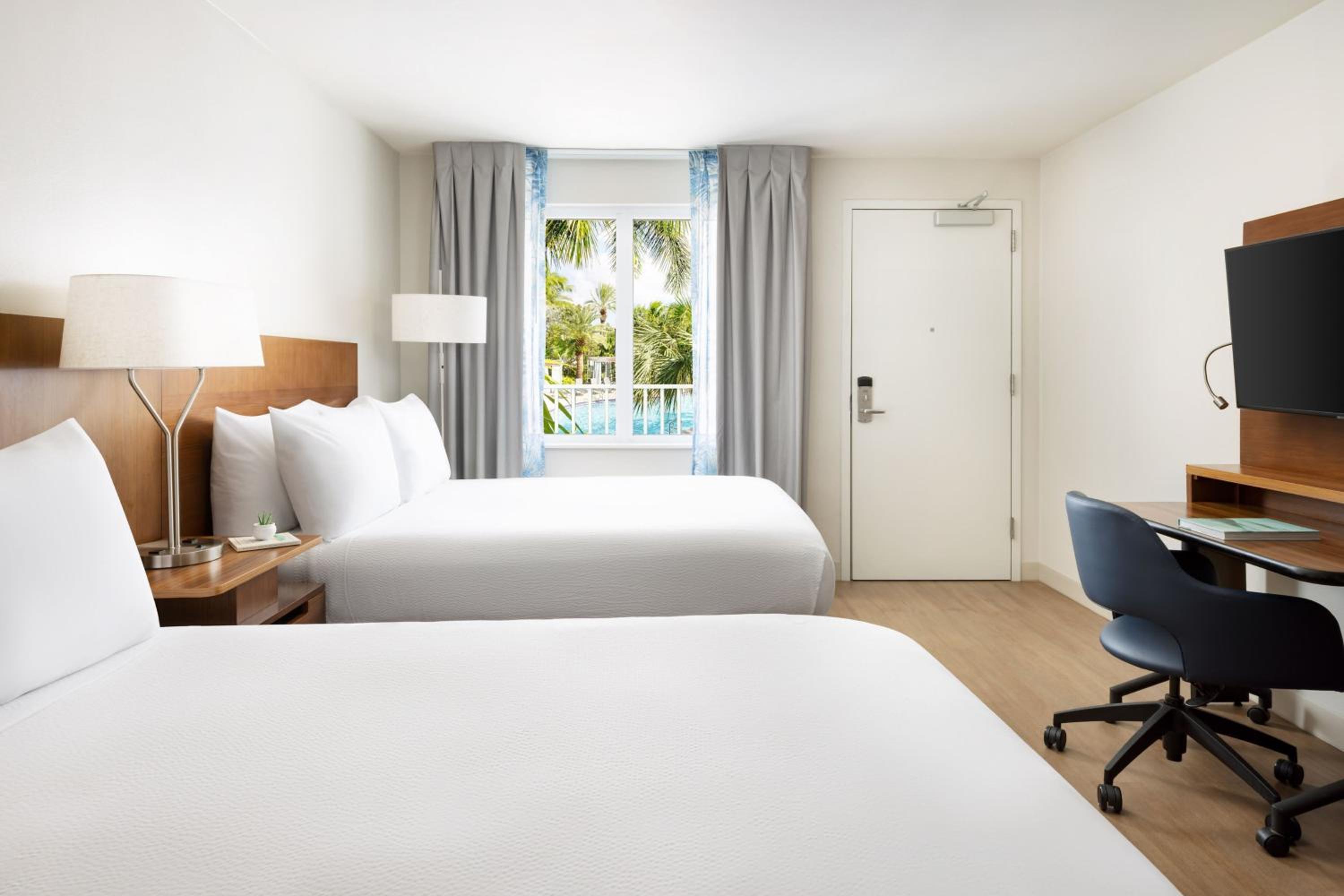 Deluxe Queen Room with Two Queen Beds and Pool View