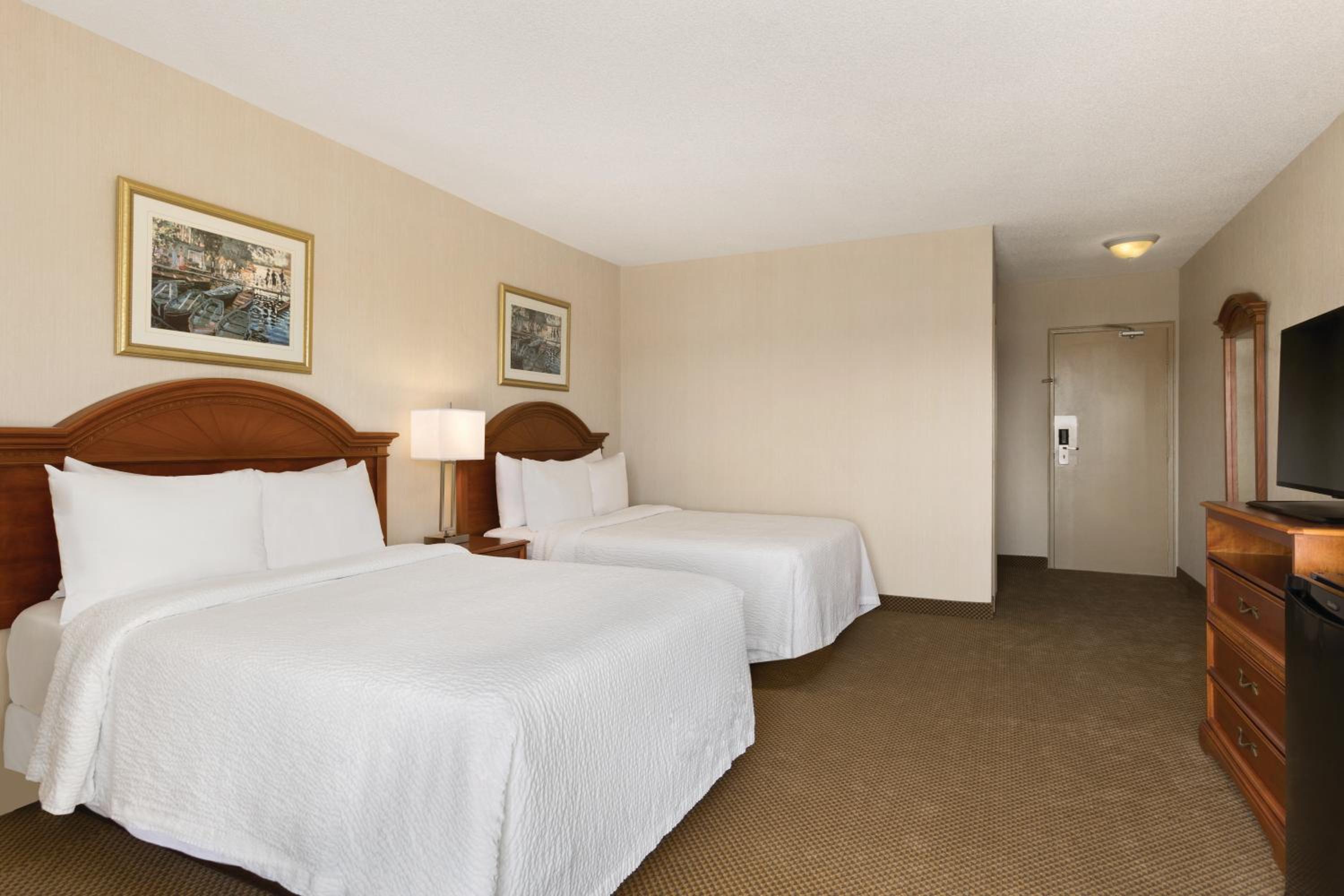 hotel room with two beds and a flat screen tv
