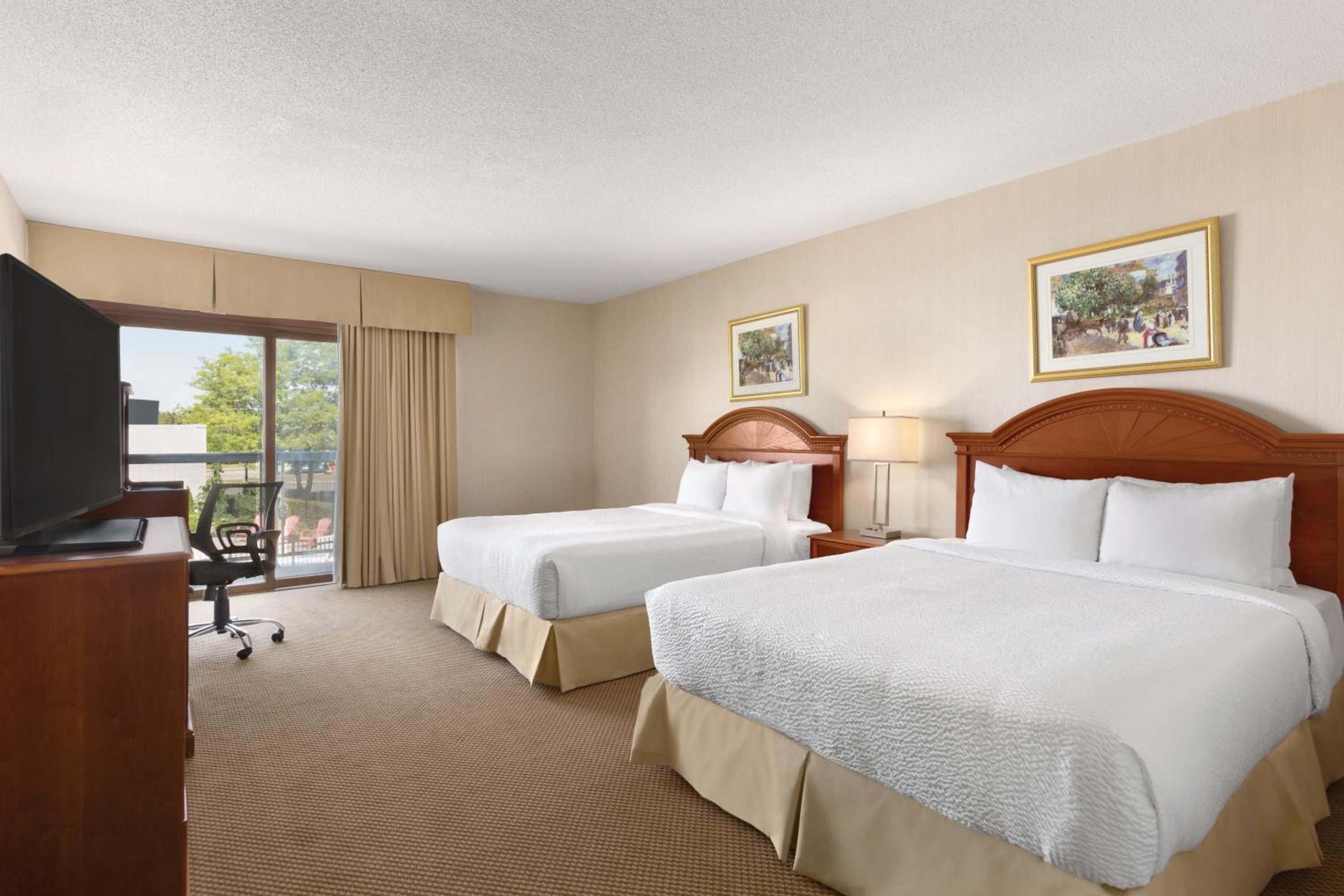 hotel room with two beds and a flat screen tv