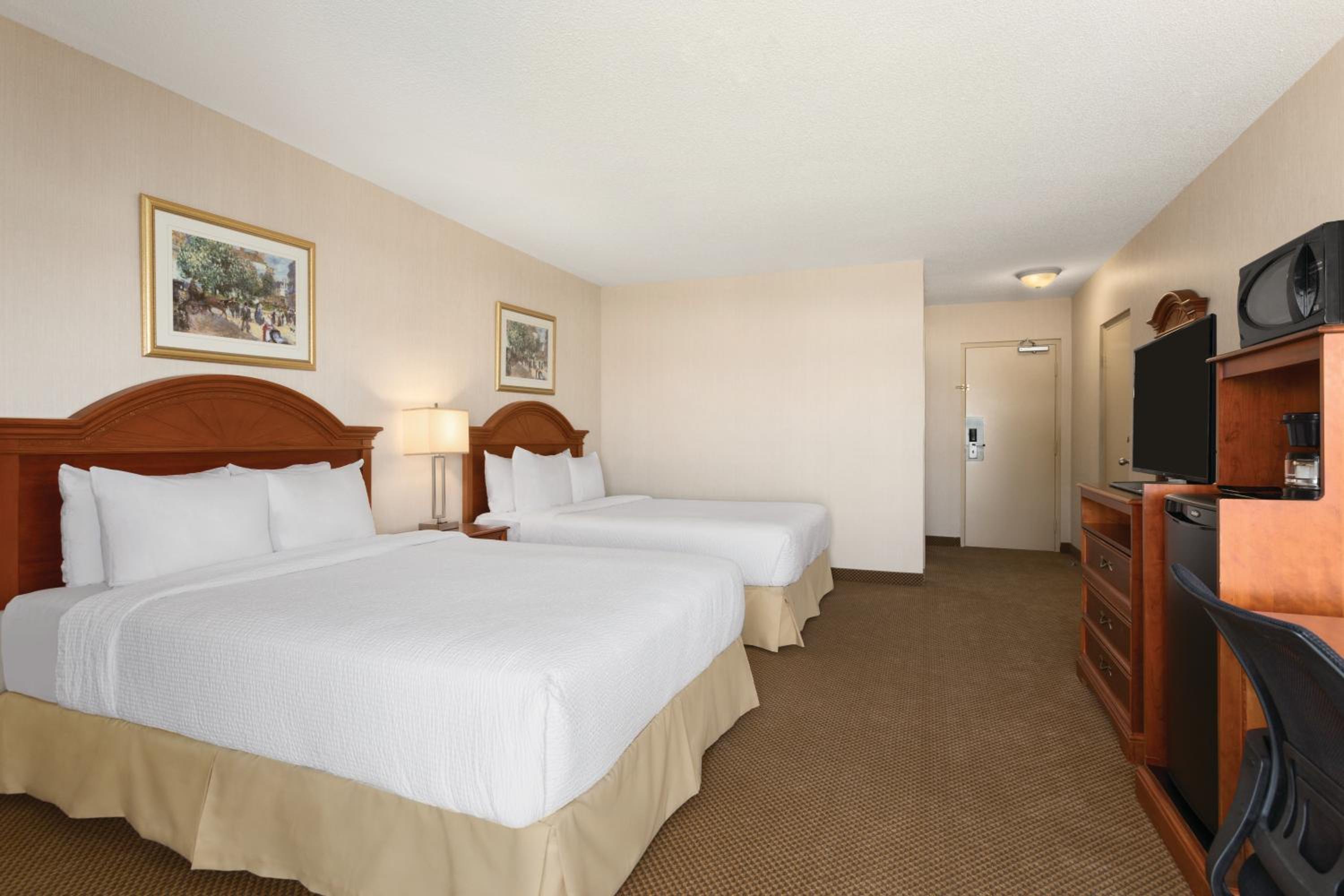 hotel room with two beds and a flat screen tv