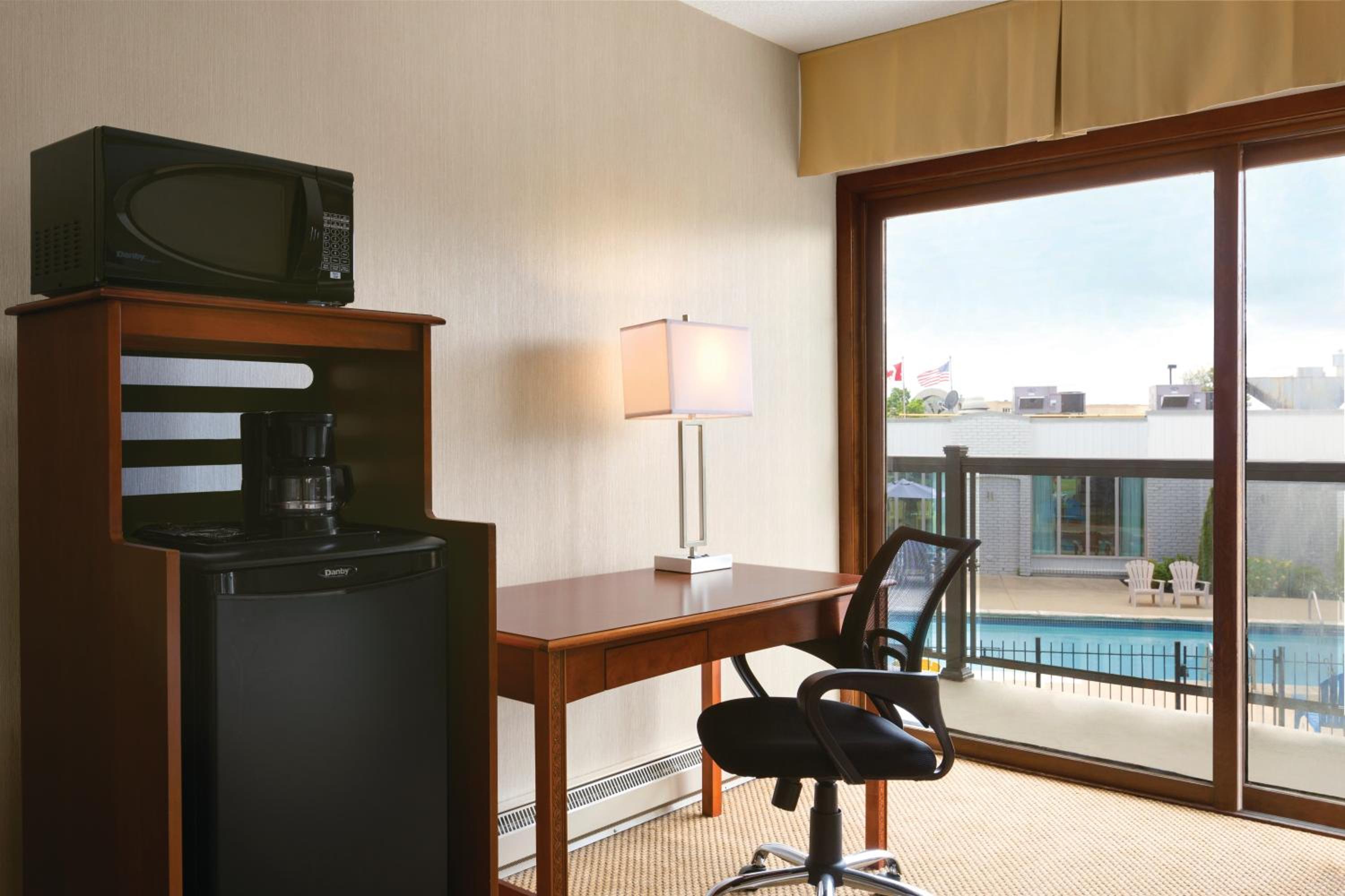 hotel room with a view of the pool and patio