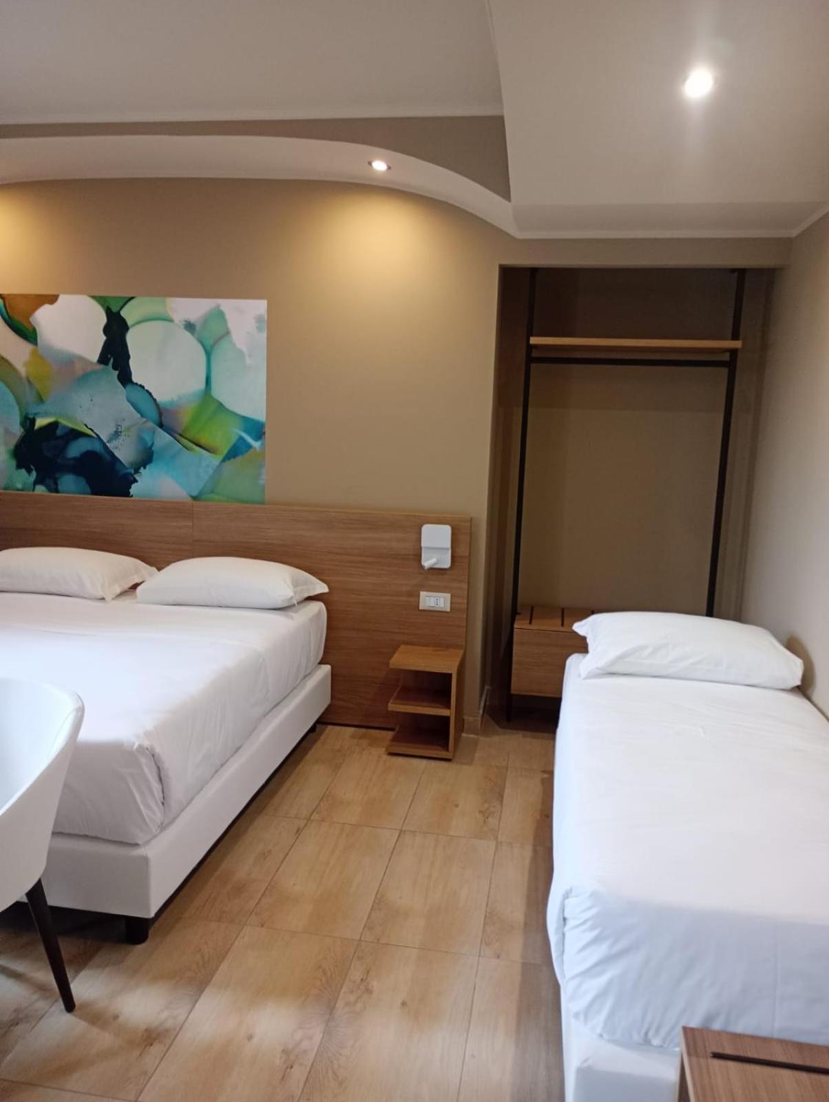 Family Room with One Queen Bed and Two Single Beds - Photo 1