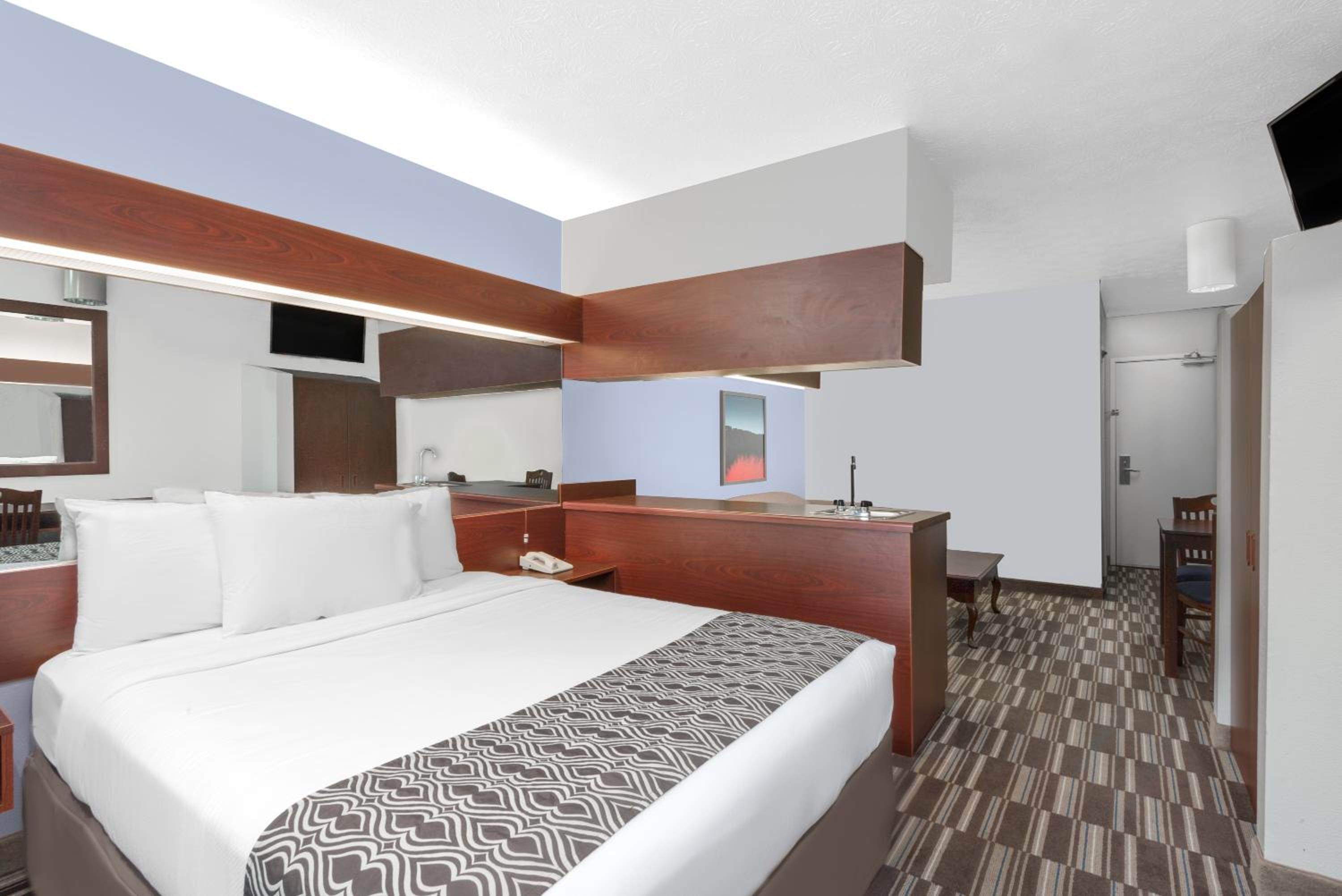 hotel room with a large bed and a flat screen tv