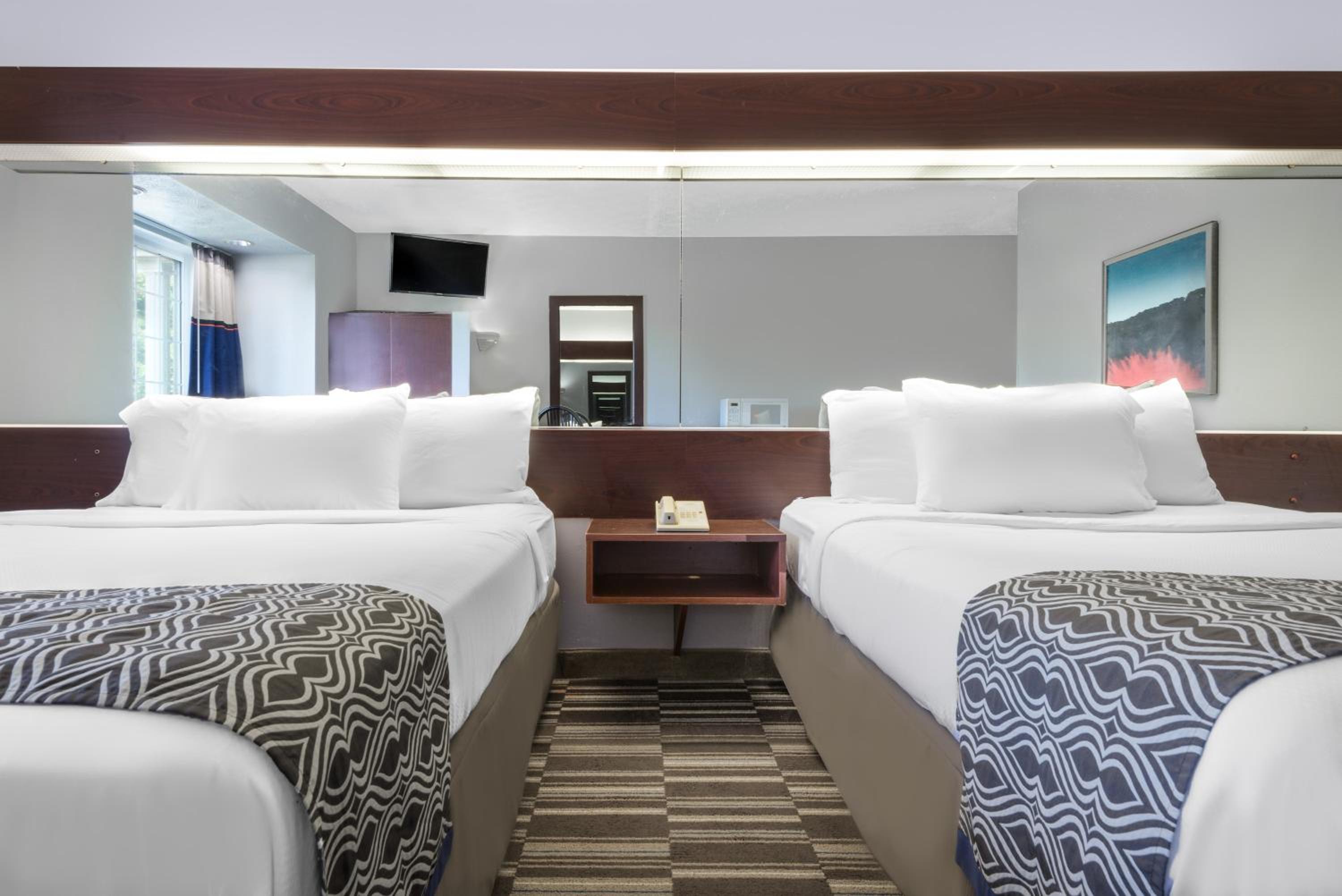 hotel room with two beds and a flat screen tv