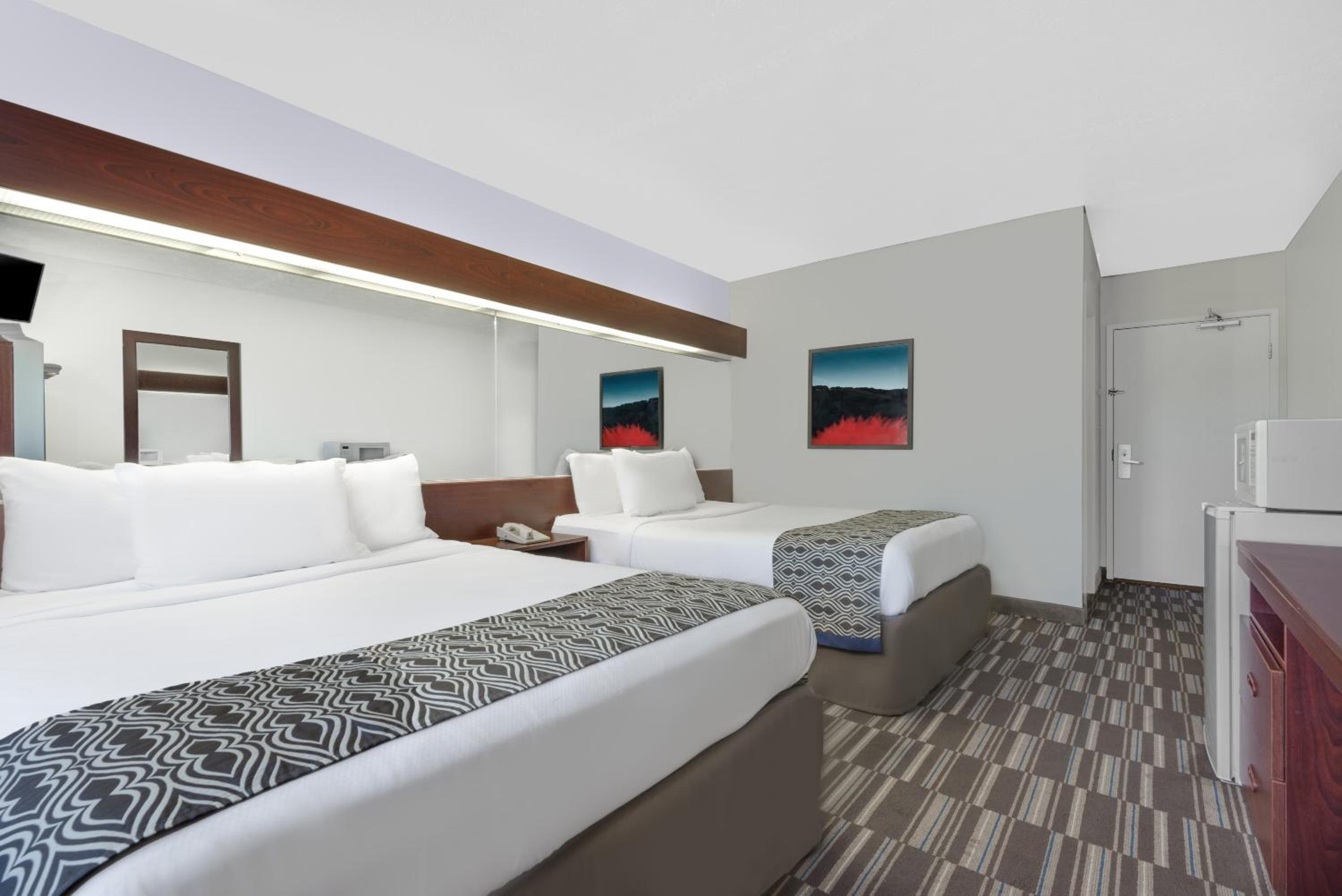 hotel room with two beds and a flat screen tv