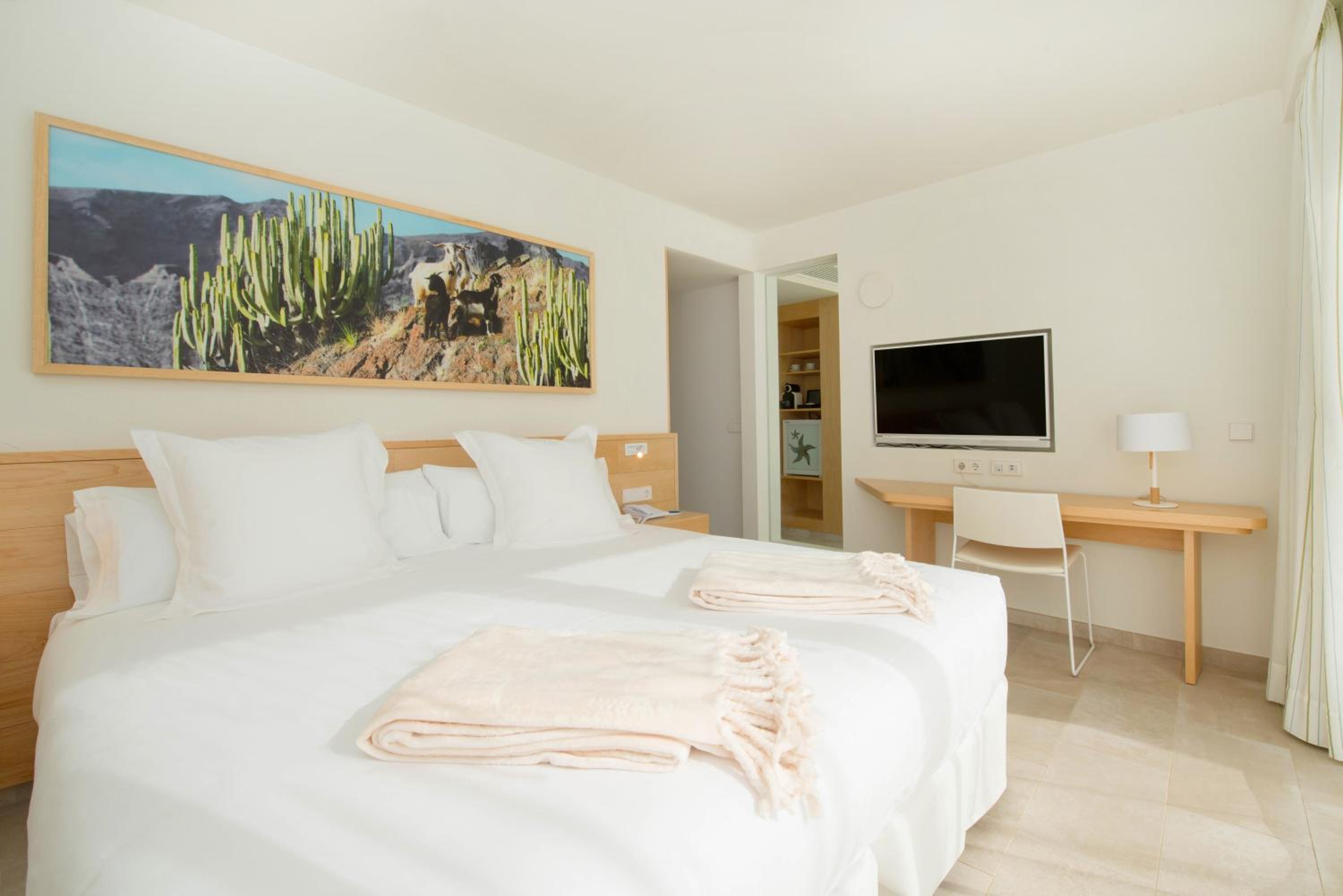 hotel room with two beds and a flat screen tv