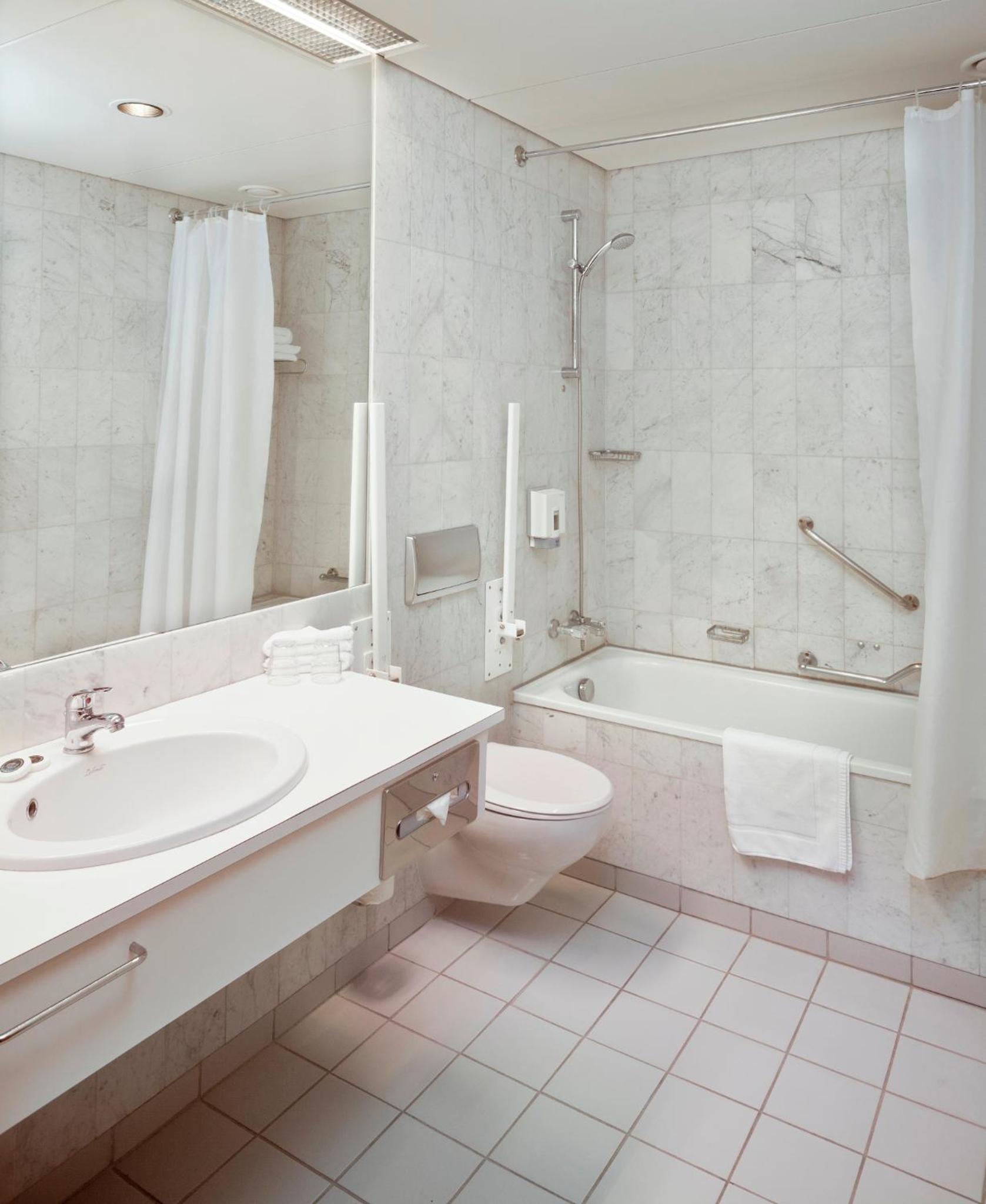 Relax in this serene, elegantly designed bath space.