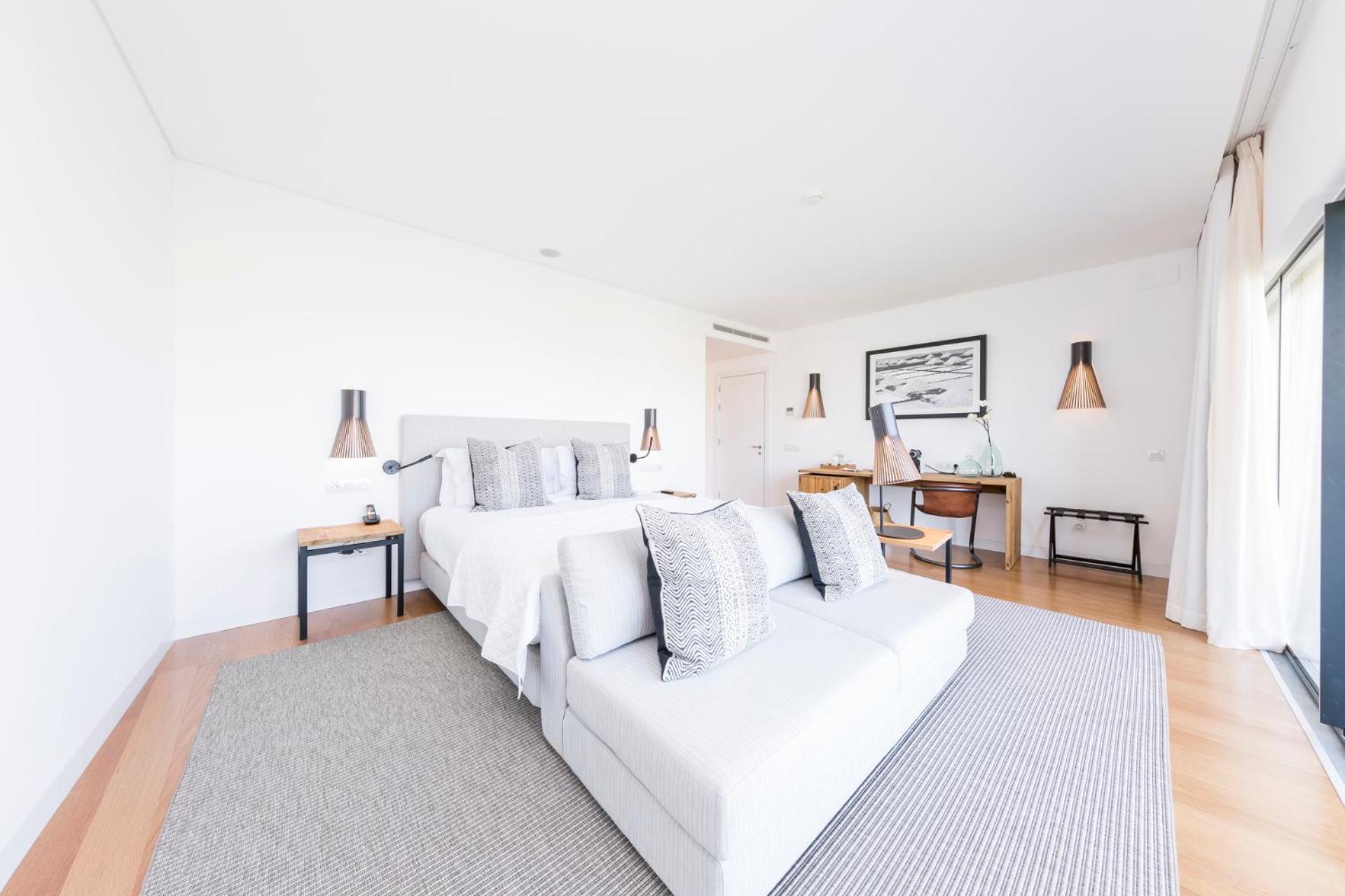 bedroom with a bed, desk, and sliding glass doors