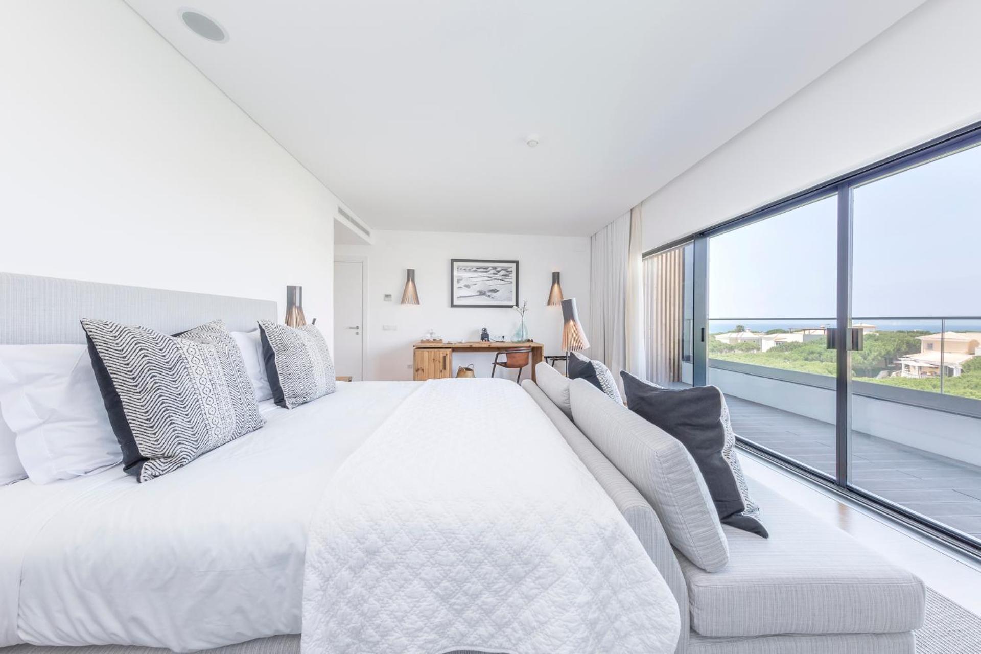 bedroom with a large bed and a view of the ocean