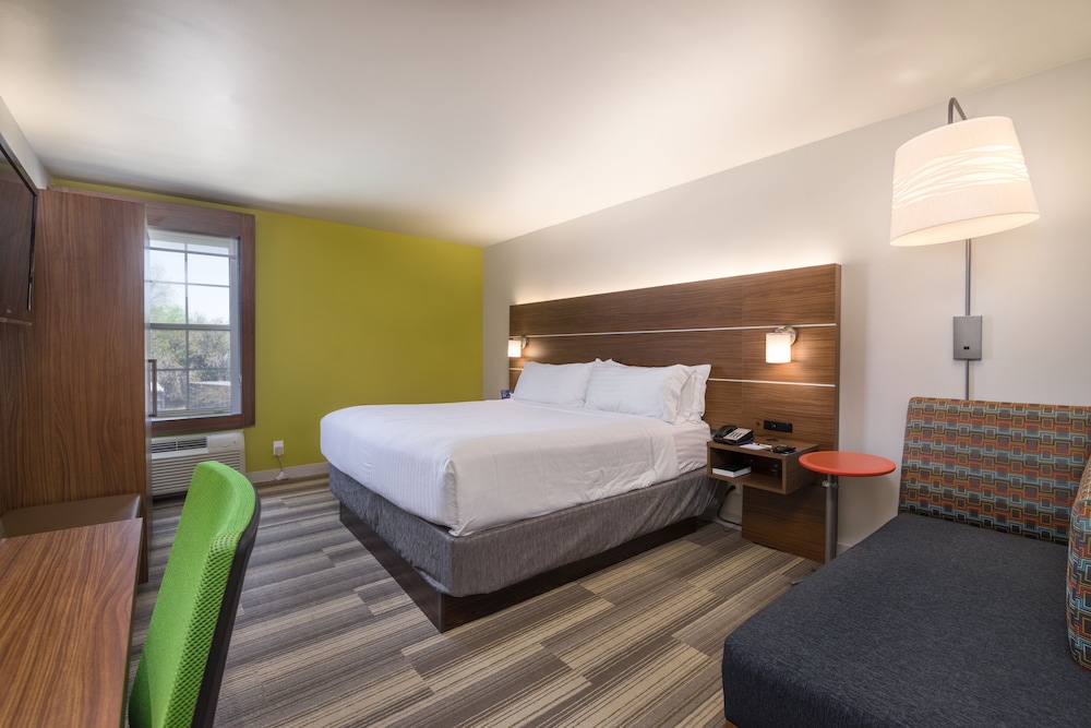hotel room with a bed, desk, and chair