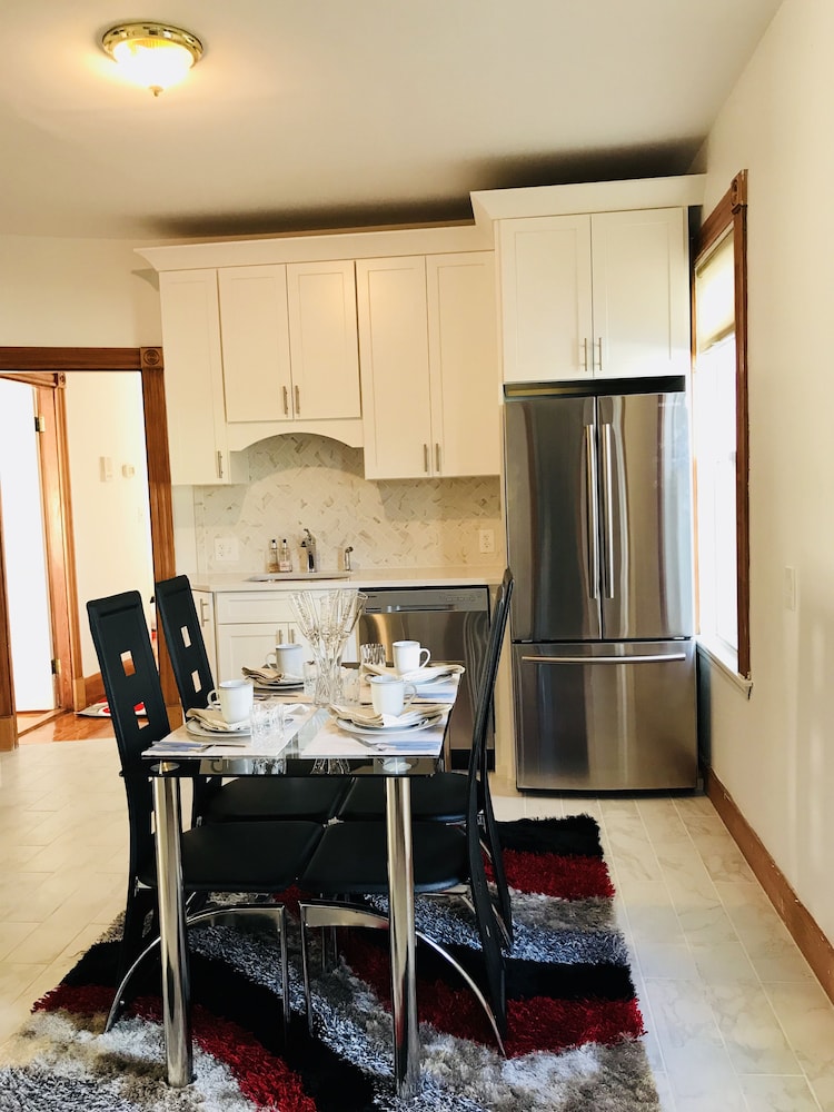 Kitchen with dining table and stainless steel refrigerator