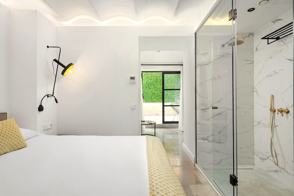 bedroom with a large bed and a walk in shower