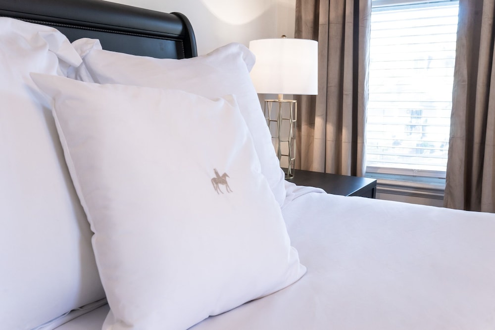 bed with two white pillows and a black headboard