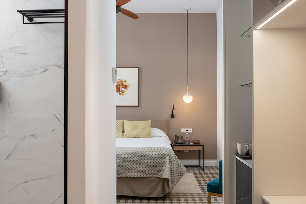 room with a bed and a ceiling fan in it
