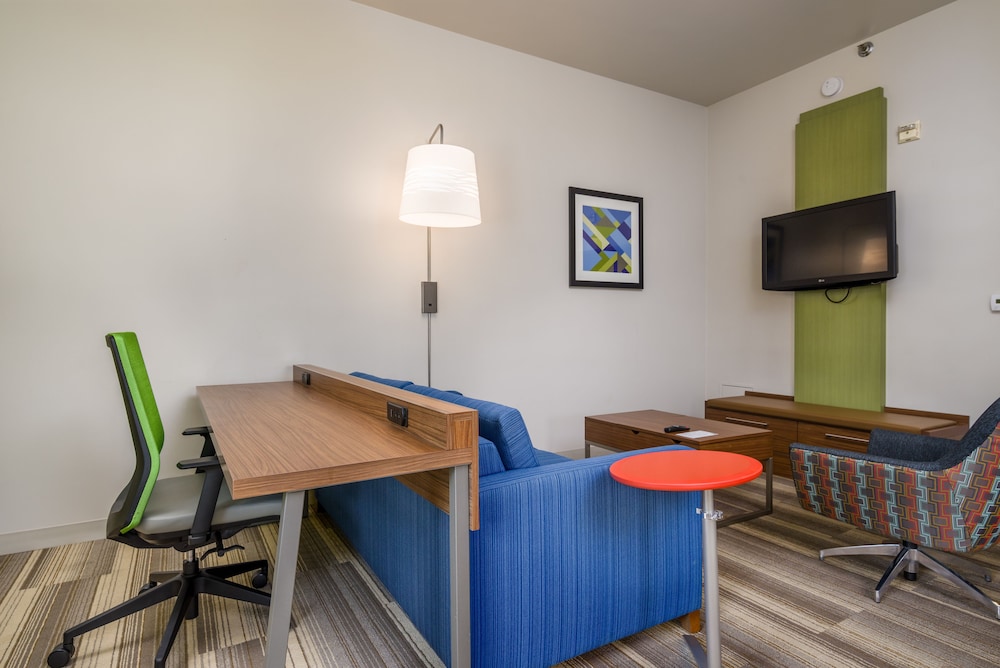living room with a desk, chair, and television