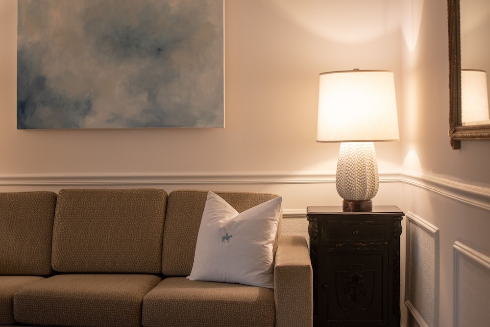 photograph of a living room with a couch and lamp