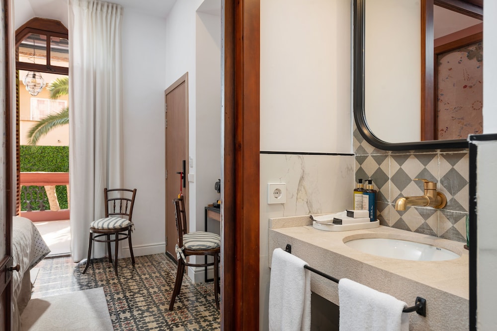 bathroom with a sink and a chair in front of it