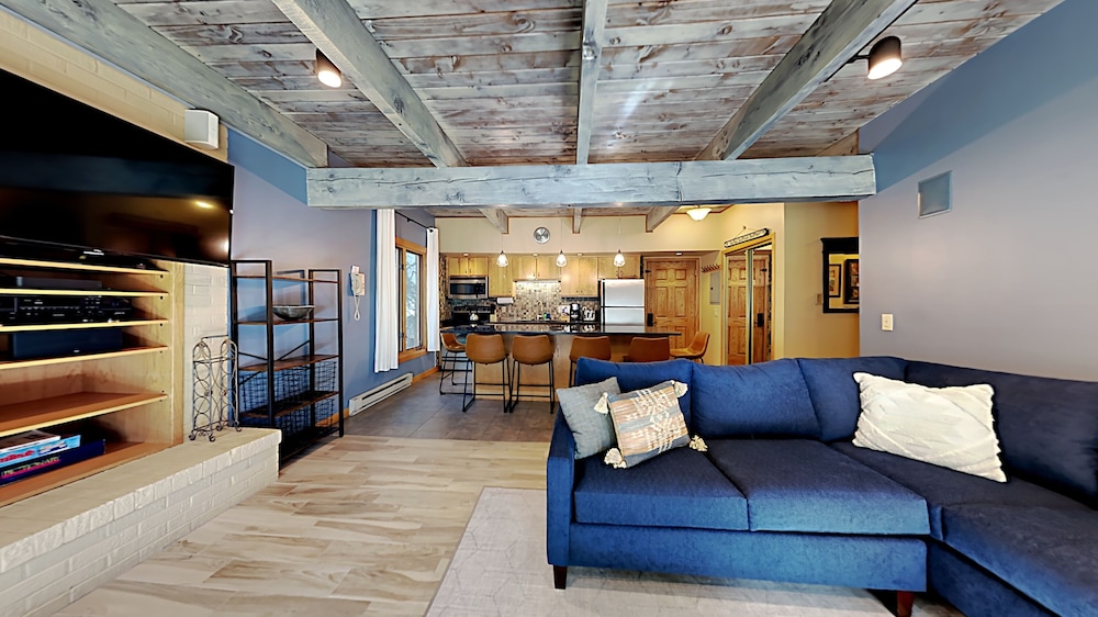 Rustic living room with blue sofa and kitchen