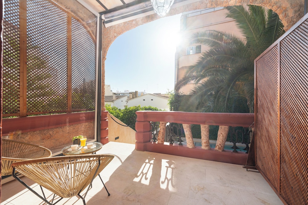 balcony with a view of the city and palm trees