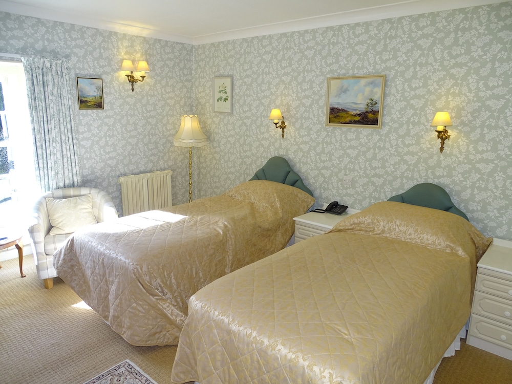 hotel room with two twin beds and a chair in the corner