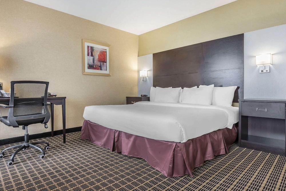 hotel room with a bed, desk, and chair