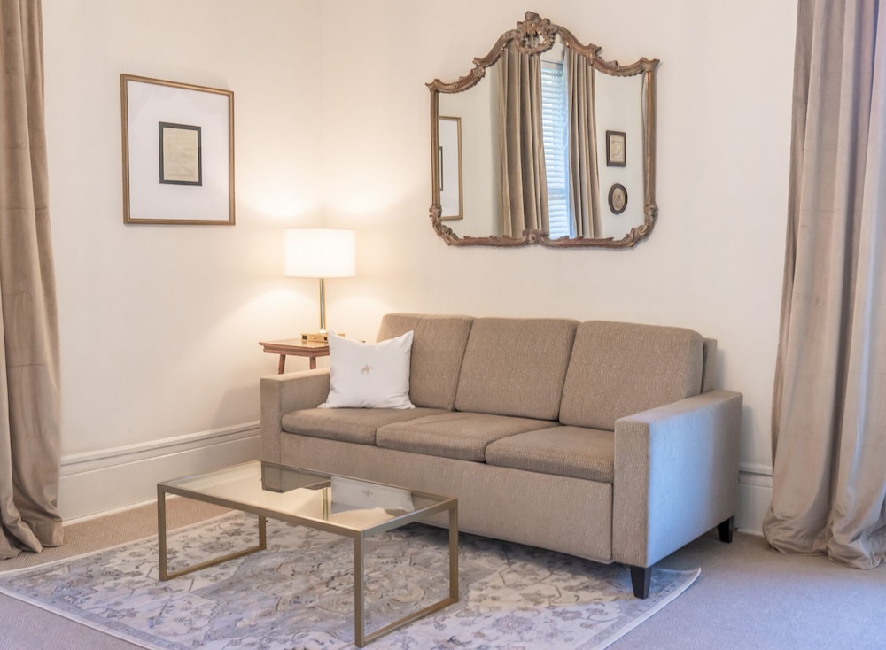 living room with a couch, coffee table and mirror