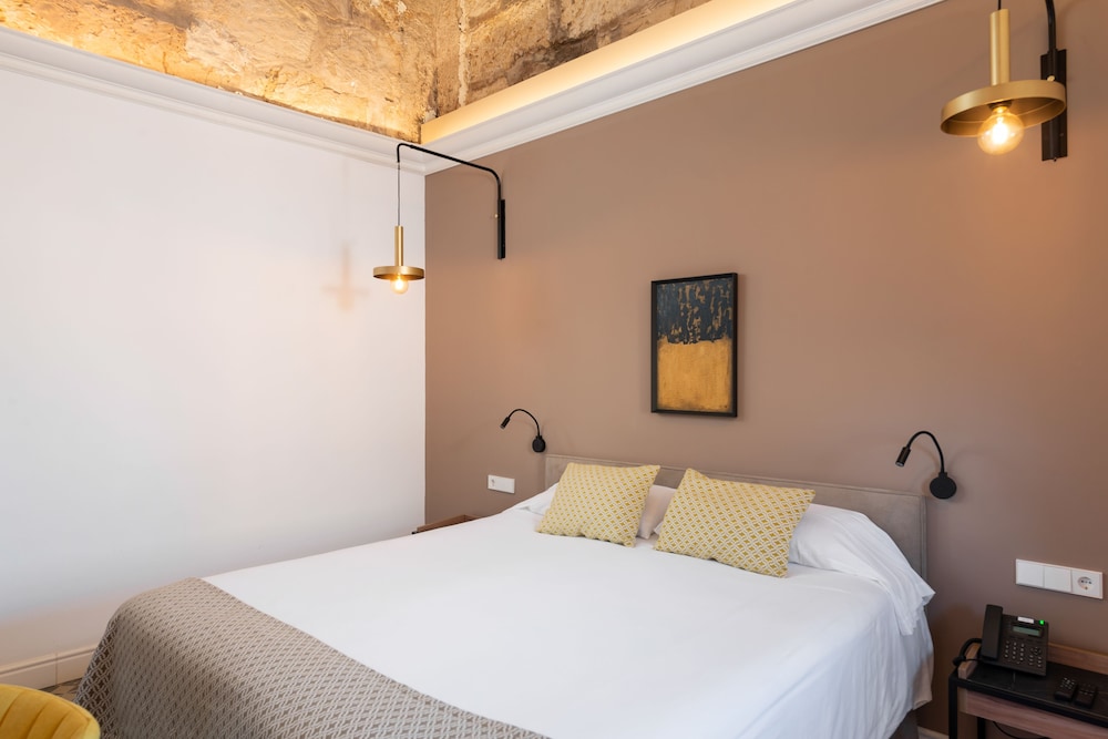 bedroom with a bed and two lamps on either side of the bed