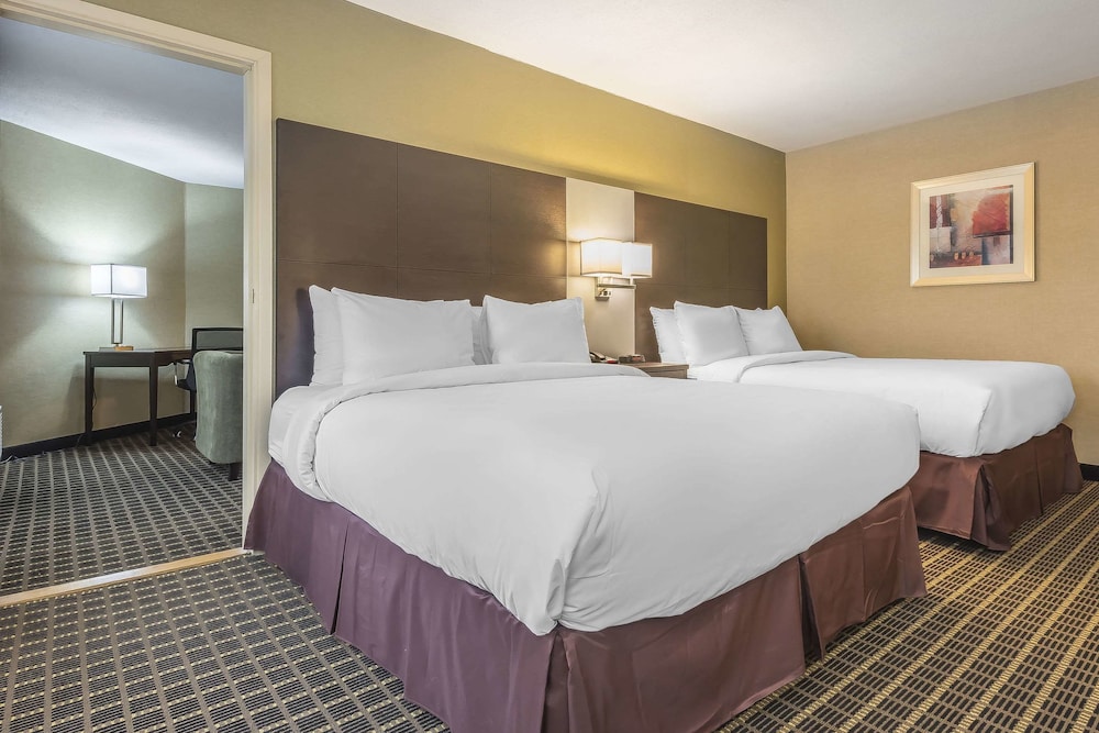 hotel room with two queen sized beds and a flat screen tv