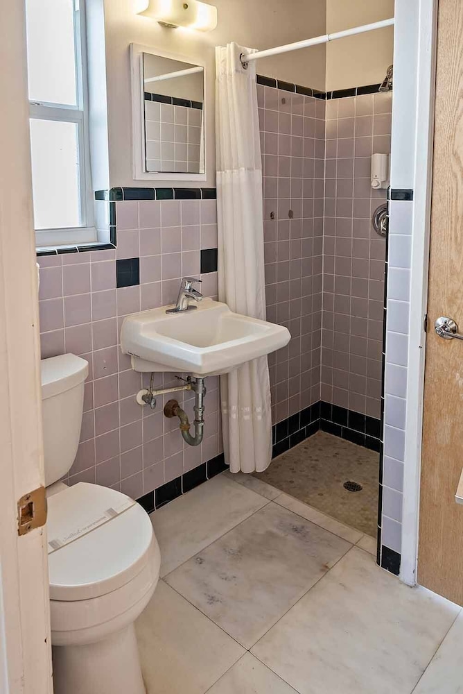 Small bathroom with toilet, sink, and shower