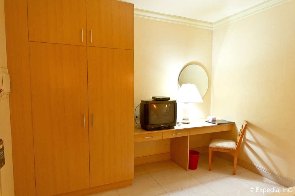 small room with an old television and desk in it