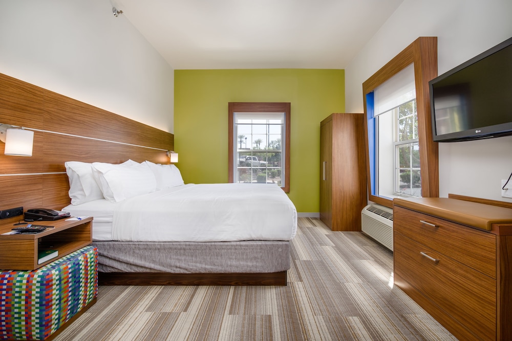 hotel room with a large bed and a flat screen tv