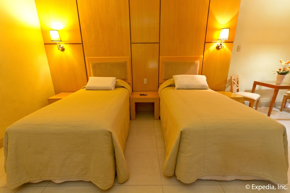 twin bed room with two beds and one table in the corner