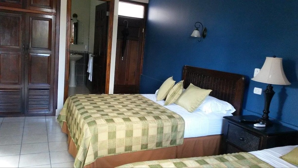 Standard Quadruple Room, 2 Queen Beds, Pool View photo 1