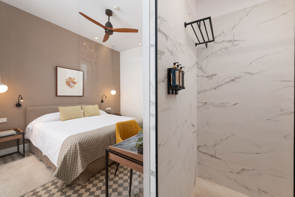 room with a bed and a ceiling fan in it