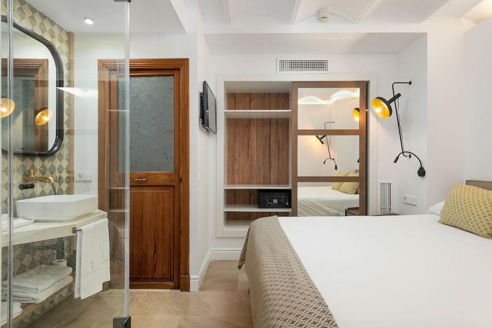 hotel room with a large bed and a walk in shower
