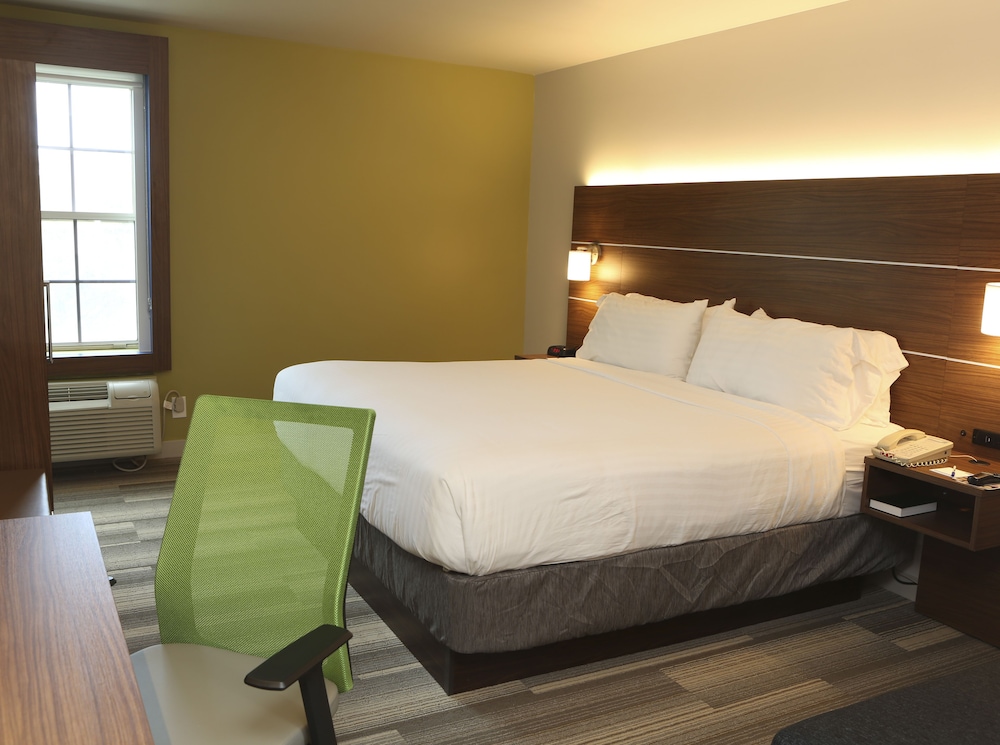 hotel room with a bed, desk, and chair